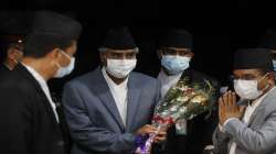 Sher Bahadur Deuba, center holding bouquet, arrives to assume office after he was sworn in as Nepals new prime minister in Kathmandu, Nepal, Tuesday.