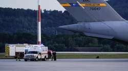 An ambulance stands next to a transport plane carrying people flown out of Afghanistan at Ramstein Air Base, in Ramstein-Miesenbach, Germany