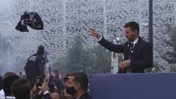 Lionel Messi throws a team jersey to Paris Saint-Germain supporters Wednesday, Aug. 11