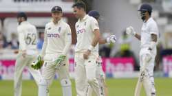 Pacer James Anderson, right, speaks to England's Jos Buttler