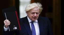 British Prime Minister Boris Johnson leaves 10 Downing Street, making his way to Parliament to debate the situation in Afghanistan, in London.