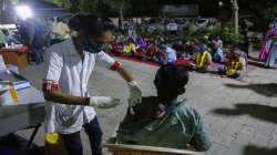 A man gets COVID-19 vaccine during a special vaccination drive at a shelter for homeless people in Ahmedabad.