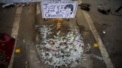 Melted candles are seen next to a placard at a demonstration site outside a crematorium where a 9-year-old girl from the lowest rung of India's caste system was, according to her parents and protesters, raped and killed earlier this week, in New Delhi.