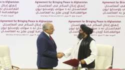 FILE - In this Feb. 29, 2020, file photo, U.S. peace envoy Zalmay Khalilzad, left, and Mullah Abdul Ghani Baradar, the Taliban group's top political leader shack hands after signing a peace agreement between Taliban and U.S. officials in Doha, Qatar.?