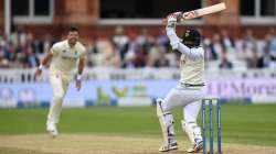 Jasprit Bumrah of India hits out at a short ball from James Anderson of England