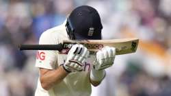 England's Joe Root puts his head on his bat as he leaves the pich after being bowled by India's Shardul Thakur on day five of the fourth Test match at The Oval cricket ground in London, Monday, Sept. 6