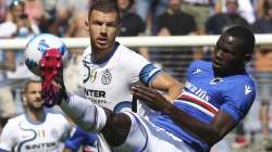 Inter's Edin Dzeko, left, and Sampdoria's Omar Colley vie for the ball during the Italian Serie A soccer match between Sampdoria and Inter Milan at the Luigi Ferraris stadium in Genoa, Italy, Sunday, Sept. 12