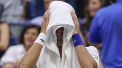 Novak Djokovic, of Serbia, cries as he sits on his bench during a changeover in the third set of the men's singles final against Daniil Medvedev, of Russia, of the US Open tennis championships, Sunday, Sept. 12