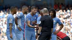 Manchester City players argue with referee Jonathan Moss who then went to watch a VAR replay before reversing his decision to give a penalty and a red card to Manchester City's Kyle Walker, second left, during the English Premier League soccer match between Manchester City and Southampton at the Etihad Stadium in Manchester, England, Saturday, Sept. 18