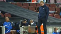 Barcelona's head coach Ronald Koeman looks down during the Spanish La Liga soccer match between Barcelona and Granada, at the Camp Nou stadium in Barcelona, Spain, Monday, Sept. 20