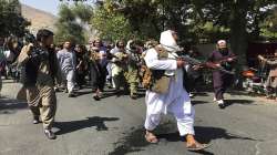 Taliban soldiers walk towards Afghans shouting slogans, during an anti-Pakistan demonstration, near the Pakistan embassy in Kabul.