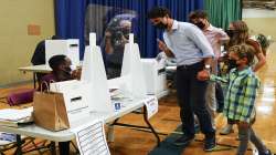 Liberal leader Justin Trudeau votes with the help of his children, clockwise from top, Xavier, Ella-Grace and Hadrien, in Montreal