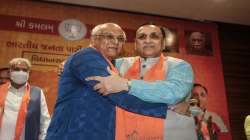 Gujarat Chief Minister Bhupendra Patel (L) and former CM Vijay Rupani (R) after a meeting in Gandhinagar.