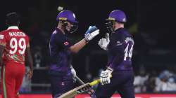 Scotland's batsman Matthew Cross, left, celebrates with teammate Richie Berrington for scoring the w