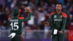 Bangladesh all-rounder Shakib Al Hasan (right) celebrates after taking a Scotland wicket with teamma