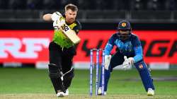 David Warner of Australia plays a shot as Kusal Perera of Sri Lanka looks on during the ICC Men's T2