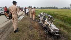 People take a look at the overturned SUV which destroyed in yesterdays violence during farmers prote