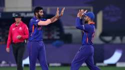 India's Jasprit Bumrah, left, celebrates the dismissal of Scotland's captain Kyle Coetzer with capta