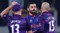 Scotland's captain Kyle Coetzer, right, and Chris Greaves greet India's captain Virat Kohli after In