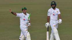 Pakistan's Abid Ali (left) and teammate Abdullah Shafique walk back to the pavilion at the end of th