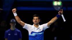 Novak Djokovic of Serbia celebrates winning his singles match against Andrey Rublev of Russia on Day