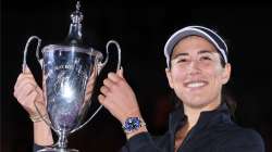 Garbiñe Muguruza of Spain poses with Billie Jean King trophy after defeating Anett Kontaveit of Esto