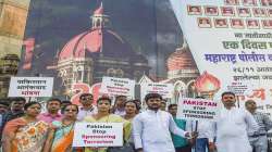 Members of Police Charitable Trust hold placards at the Gateway of India to mark the 13th anniversary of the 26/11 terror attacks, in Mumbai, Friday, Nov. 26, 2021.?