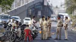 Police personnel stop migrants on their way back to reach native places on Eastern Express Highway, during a nationwide lockdown as a preventive measure against the coronavirus pandemic, at Mulund in Mumbai.