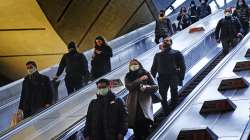 Commuters in Canary Wharf underground tube station wear face masks to curb the spread of COVID-19, now mandatory on public transport in Britain after the emergence of new Omicron variant, in London.