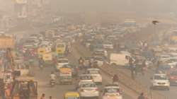 Vehicles ply amid low visibility due to a thick layer of smog in Gurugram.