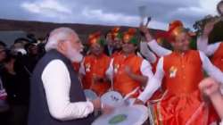 PM Modi plays drums as he greets the Indian diaspora at Glasgow, Scotland.