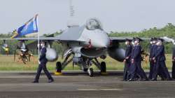 Taiwanese Air Force personnel pass by one of the newly commissioned upgraded F-16V fighter jets at Air Force base in Chiayi in southwestern Taiwan on Nov 18