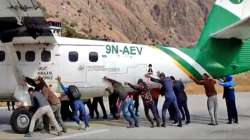 Passengers pushed the stranded twin otter aircraft belonging to Tara Air off the runway.?