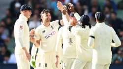 James Anderson of England celebrates with teammates after dismissing David Warner of Australia durin