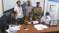 Seif al-Islam, center, the son and one-time heir apparent of late Libyan dictator Moammar Gadhafi registers his candidacy on November 14 for the presidential elections. 