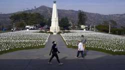 Visitors walk around a memorial for victims of COVID-19 at the Griffith Observatory