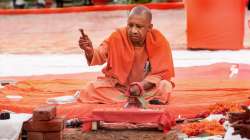 Uttar Pradesh Chief Minister Yogi Adityanath during the foundation stone laying of the houses to be constructed under Pradhan Mantri Awas Yojana, at Lukarganj in Prayagraj, Sunday, December 26, 2021.