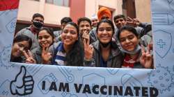 Students pose for photographs after being administered with a COVID-19 vaccine in Jammu, Monday, Jan. 3, 2022.?