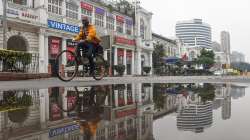 A man rides a bicycle at the deserted Connaught Place.