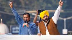 Delhi Chief Minister and Aam Aadmi Party President Arvind Kejriwal and MLA Constituency Sangrur Bhagwant wave hands to supporters during a peace march, ahead of the 2022 Punjab assembly elections in Patiala. 