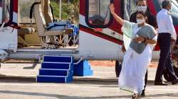 West Bengal CM Mamata Banerjee waves at her supporters as she departs for Kolkata after her three day visit to Gangasagar, in South 24 Parganas district, Thursday, Dec. 30, 2021.