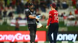 Daryl Mitchell of New Zealand interacts with Eoin Morgan of England following the ICC Men's T20 Worl