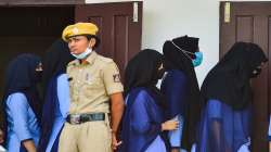 Students walk to the Principals Chamber for a meeting after they were not allowed to enter the PU College while wearing Hijab, in Udupi,