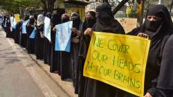 Muslim women hold placards while wearing burqa and hijab during a protest in support of female Muslim students and against the Karnataka government, in Hyderabad, Tuesday, Feb. 15, 2022.