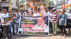 BJP activists stage a protest demanding resignation of NCP leader Nawab Malik, who was arrested by ED is a money laundering case, in Mumbai, Thursday, Feb. 24, 2022.