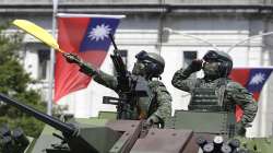 ?
FILE - Taiwanese soldiers salute during National Day celebrations in front of the Presidential Building in Taipei, Taiwan on Oct. 10, 2021. As Russia presses ahead with its attack on Ukraine, many analysts and internet users have drawn comparisons to Taiwan, another place that could face an invasion by its larger neighbor, in this case China.