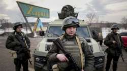 Ukrainian National guard soldiers guard a mobile checkpoint together with the Ukrainian Security Service agents and police officers during a joint operation in Kharkiv, Ukraine, Thursday, Feb. 17, 2022. 
 