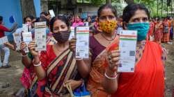 Beneficiaries show their Aadhaar Card as they wait to receive a dose of COVID-19 vaccine in Nadia district, Friday, Sept. 10, 2021.