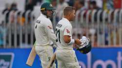 Australia's Usman Khawaja, left, and David Warner walks back to pavilion on the end of the second da