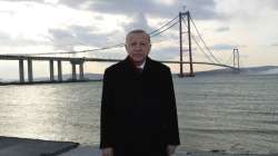 Turkey's President Recep Tayyip Erdogan poses for photos in front of the 1915 Canakkale Bridge, in ?anakkale, western Turkey